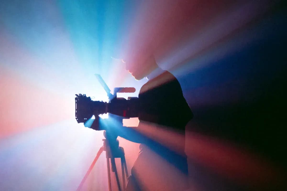 Person filming with camera in light